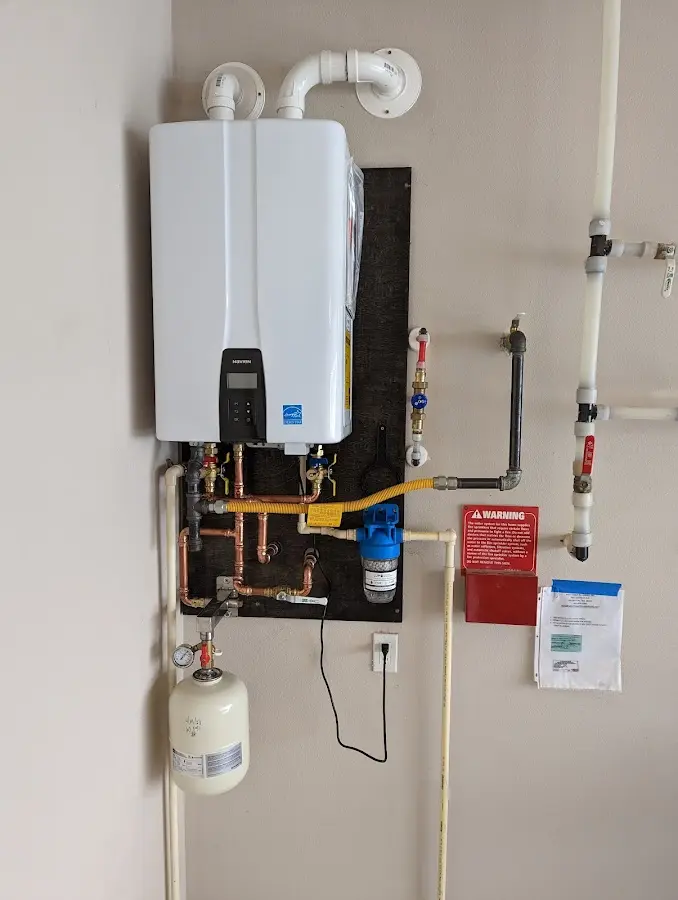 Professional plumber installing copper piping in a Saylorville home